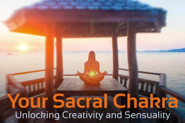woman meditating with sacral chakra shining, text underneath that says 'your sacral chakra, unlocking creativity and sensuality'